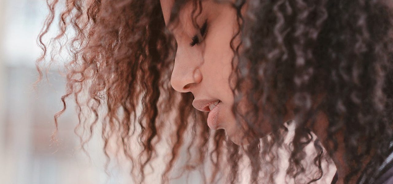 Woman closing her eyes and practicing deep breathing