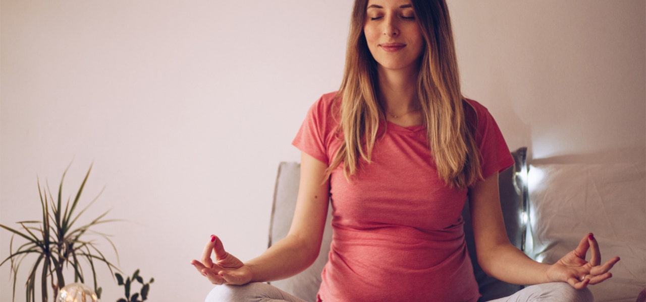 Pregnant woman meditating in a calm environment