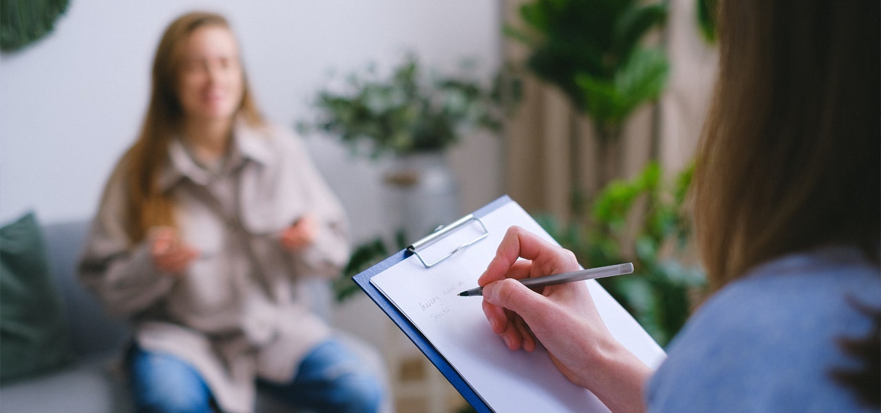 Sleep therapist taking notes during a CBT-I session