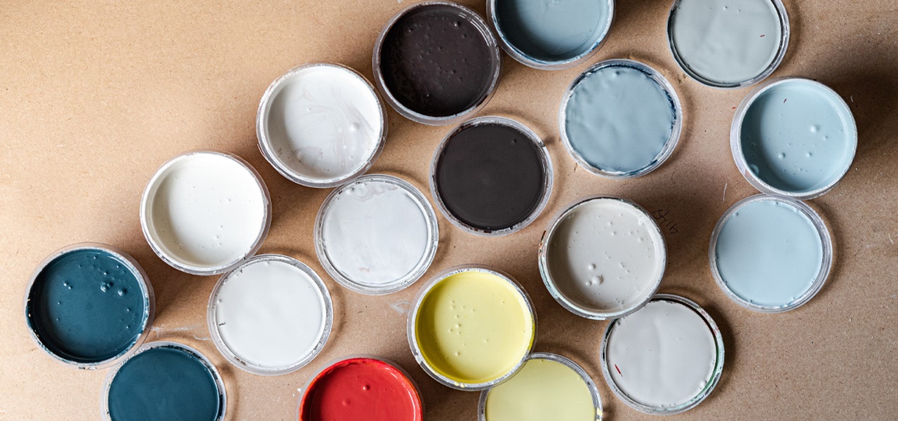 Colorful cans of paint that likely off-gas VOCs