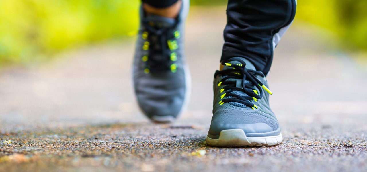 Close-up image of someone's feet walking in athletic shoes