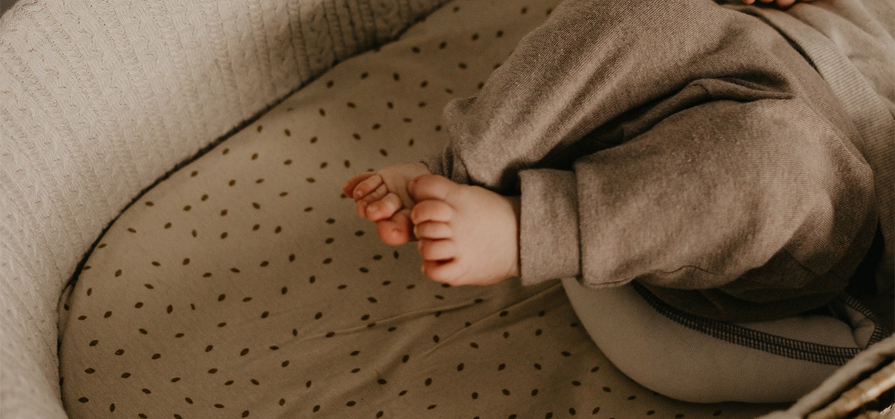 Baby's sweet little feet in their bassinet