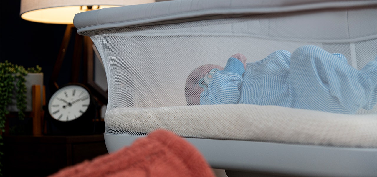 Small infant sleeping on a Natureopedic organic bassinet matress