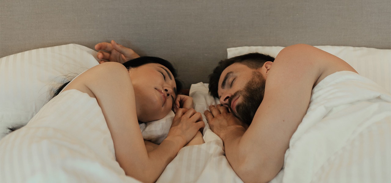 Man and woman lying in bed and sleeping soundly