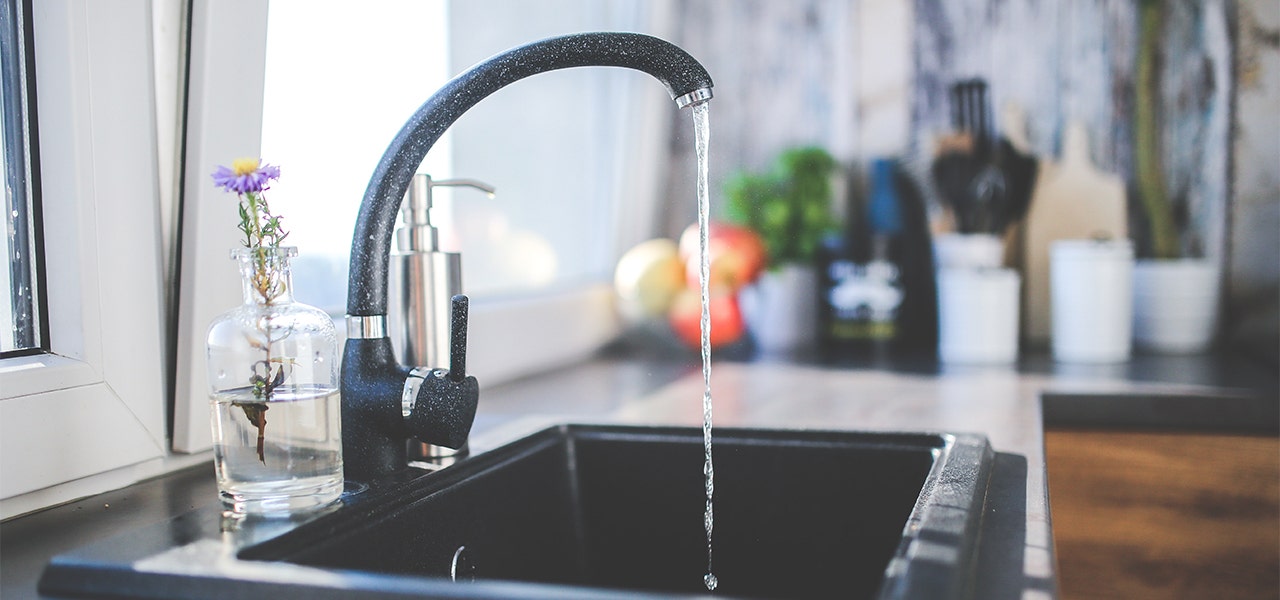 Kitchen sink with water running from the tap