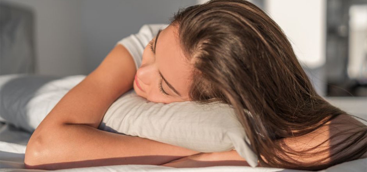 Sleepy woman lying in bed