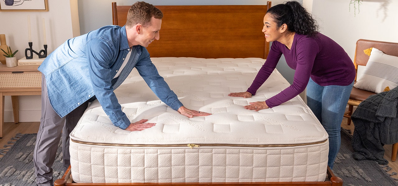 Couple setting up their new Naturepedic EOS organic mattress