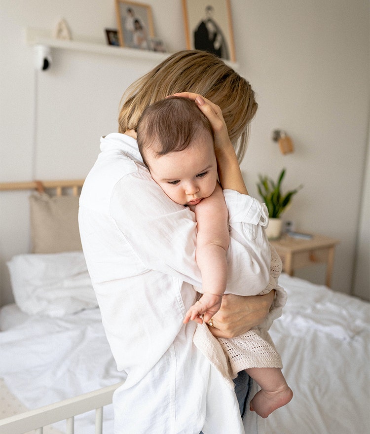 Mother holding baby and snuggling close