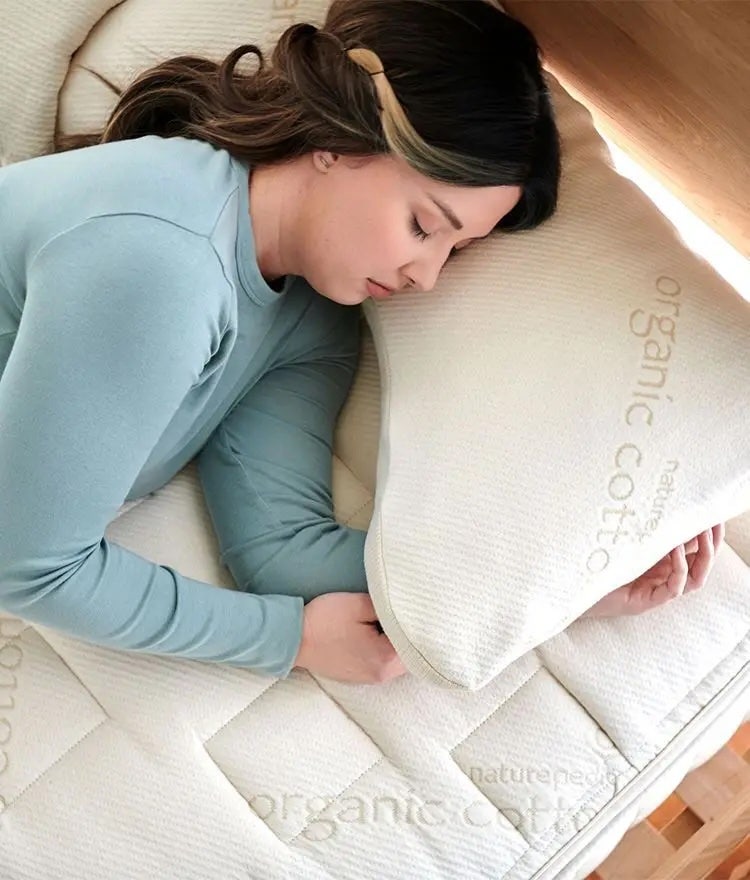 Woman laying on a naturepedic organic mattress