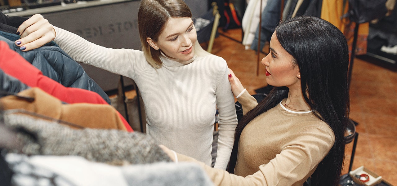 Two women shopping in a secondhand clothing store