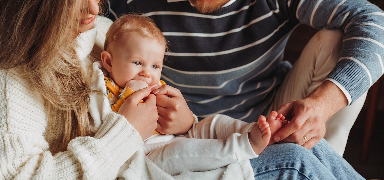 Mom and dad comforting a teething baby