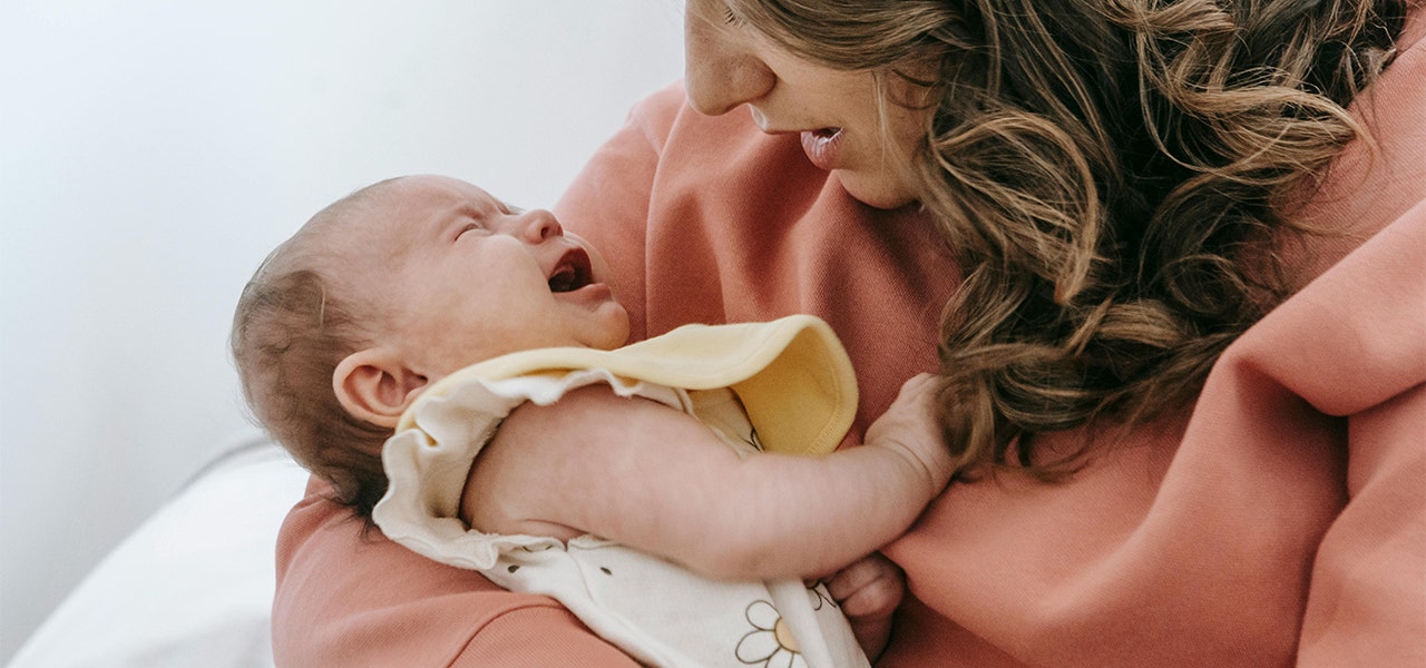 parent holding crying baby