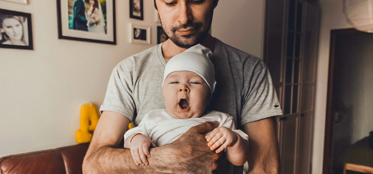 parent holding yawning baby