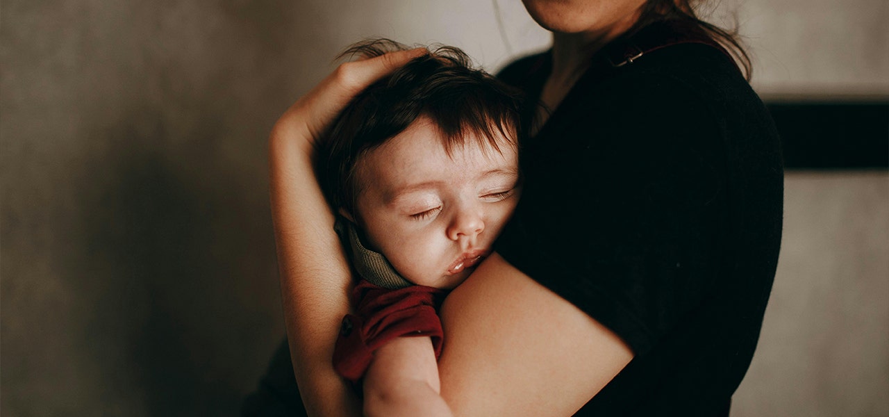baby being held by parent
