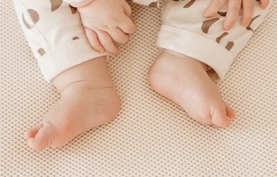 baby feet on a breathable crib mattress