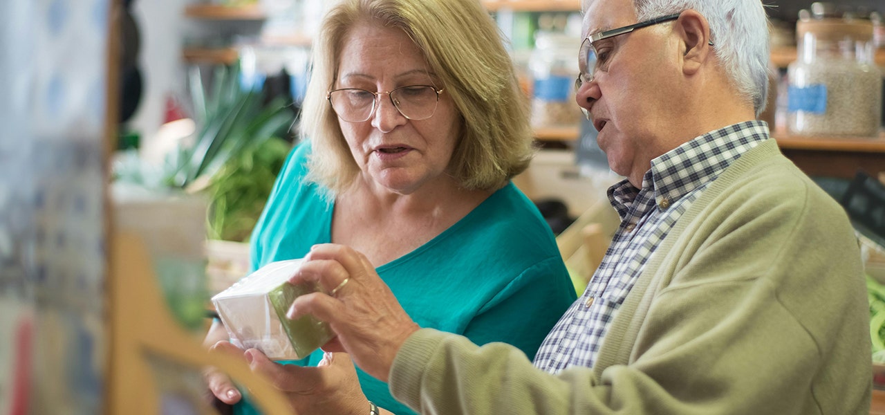 Elderly couple reading a product label