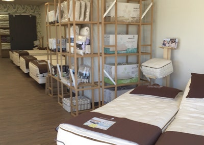 mattresses and accessory rack inside organic mattress gallery in Minneapolis Minnesota