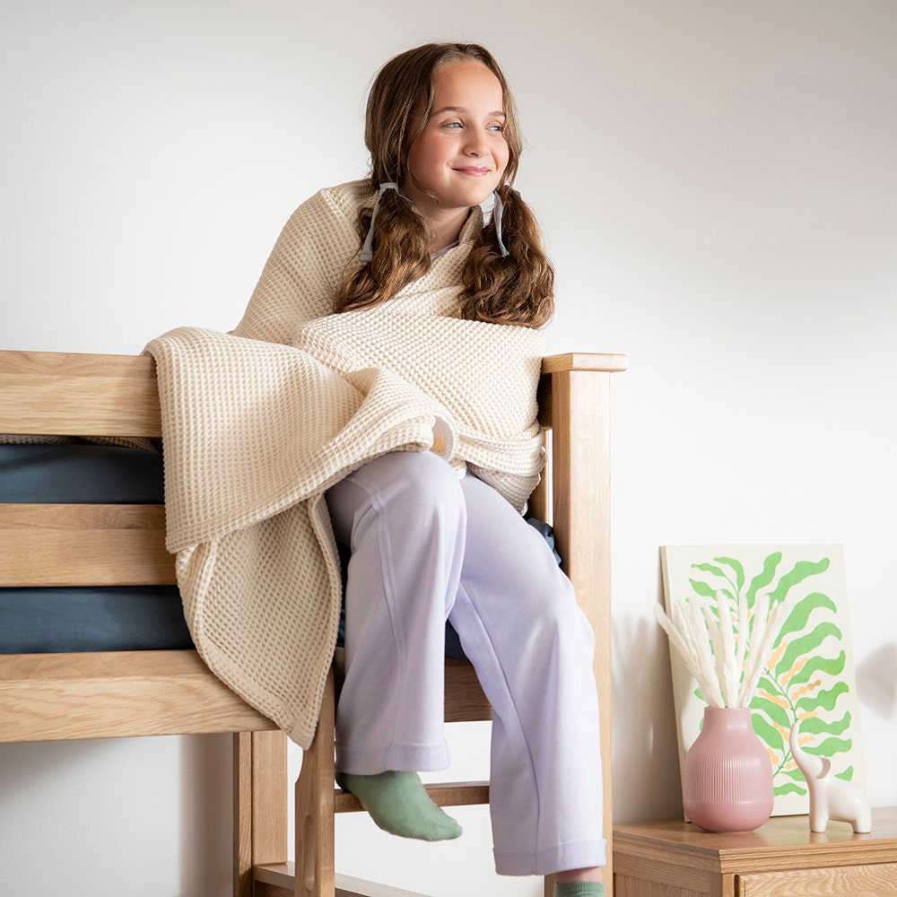 Girl wrapped in waffle blanket