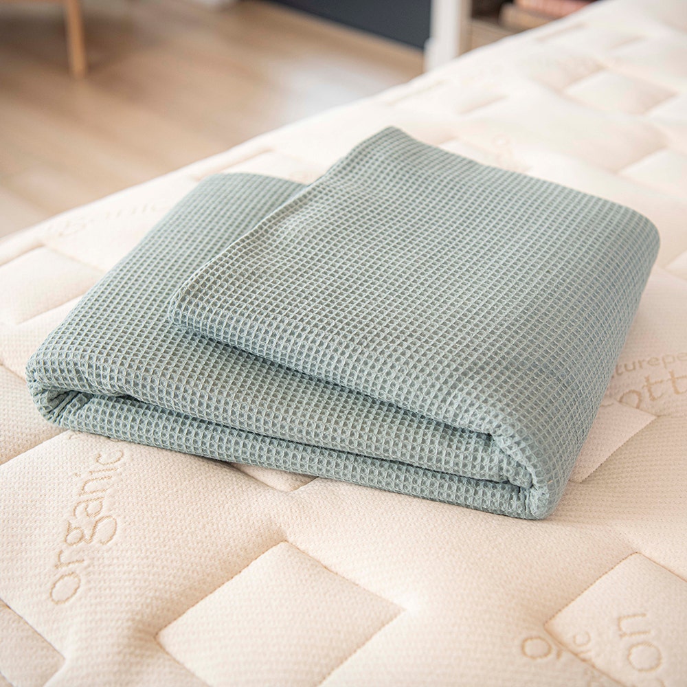 Waffle blanket folded on bed